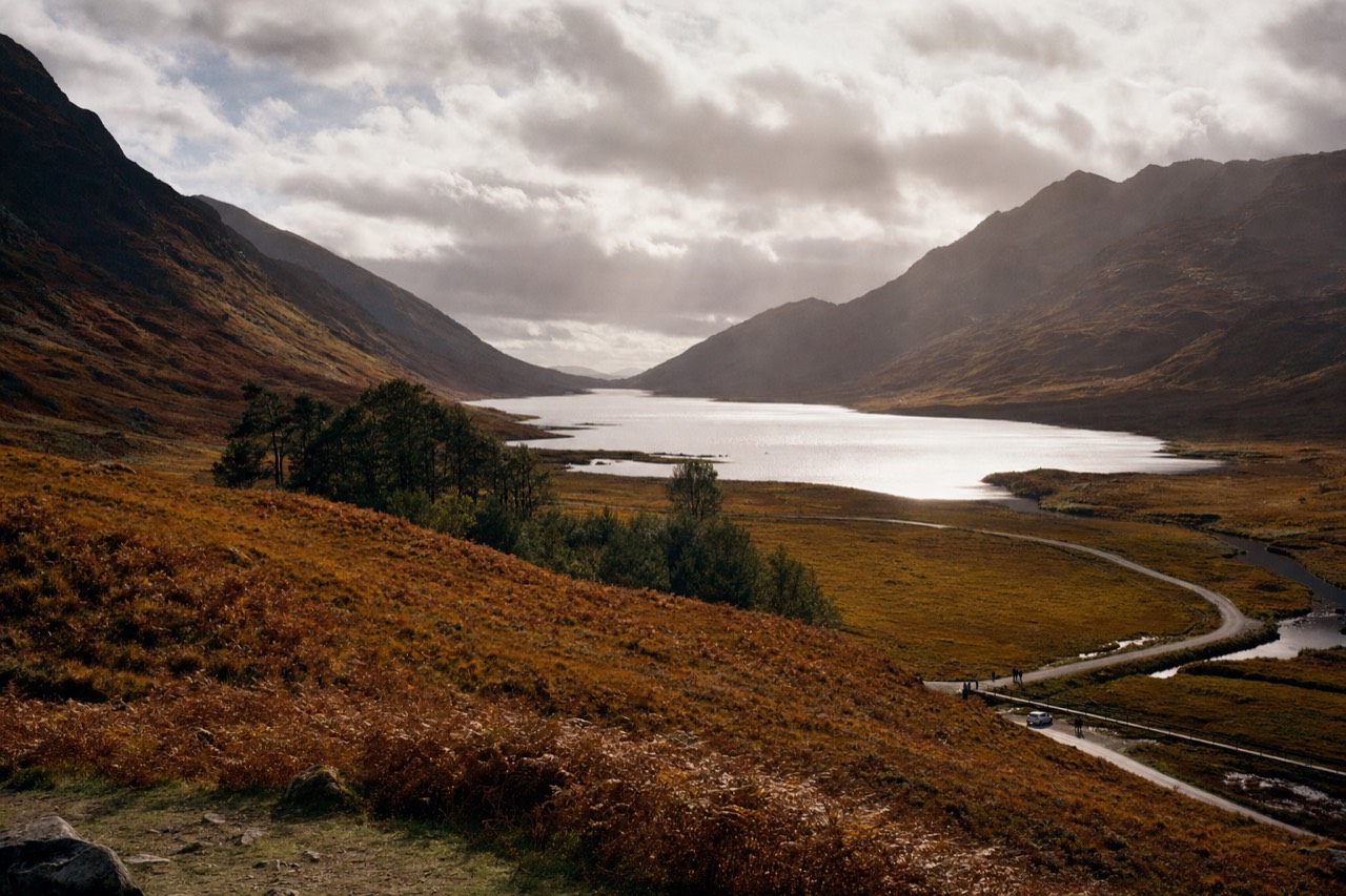 A Highland glen in early autumn with bracken turning copper on the slopes and low sun across the valley floor.